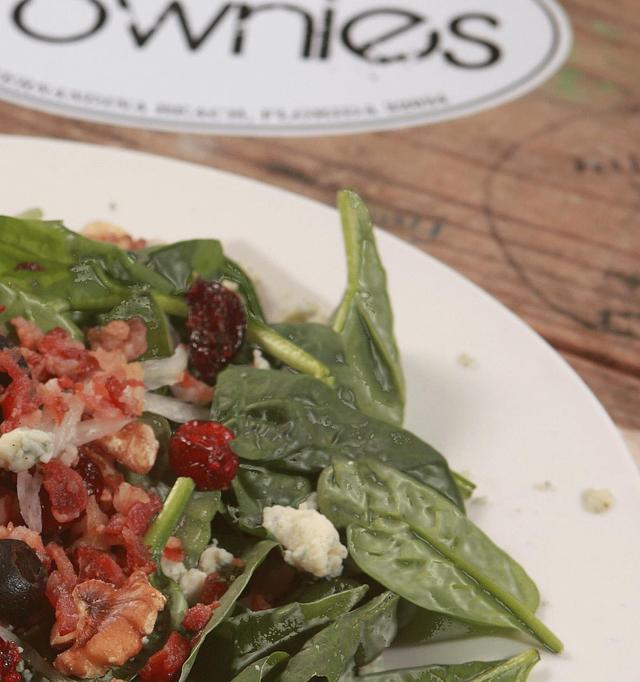 Product: Crispy Bacon, vine-ripened Tomatoes, dried Cranberries,  sliced Onion,  sprinkled with Black Olives and Bleu Cheese Crumbles, over a bed of fresh spinach  and drizzled with Balsamic Vinaigrette. - Townies Pizzeria in Fernandina Beach, FL Italian Restaurants