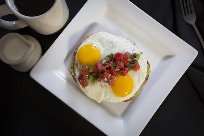 Product: Whole wheat toast with smashed avocado and two eggs your way
topped with pico de gallo, olive oil, cracked black pepper, and sea salt. - Midtown Cafe in Nashville, TN American Restaurants Product: Whole wheat toast with smashed avocado and two eggs your way
topped with pico de gallo, olive oil, cracked black pepper, and sea salt. - Midtown Cafe in Nashville, TN American Restaurants