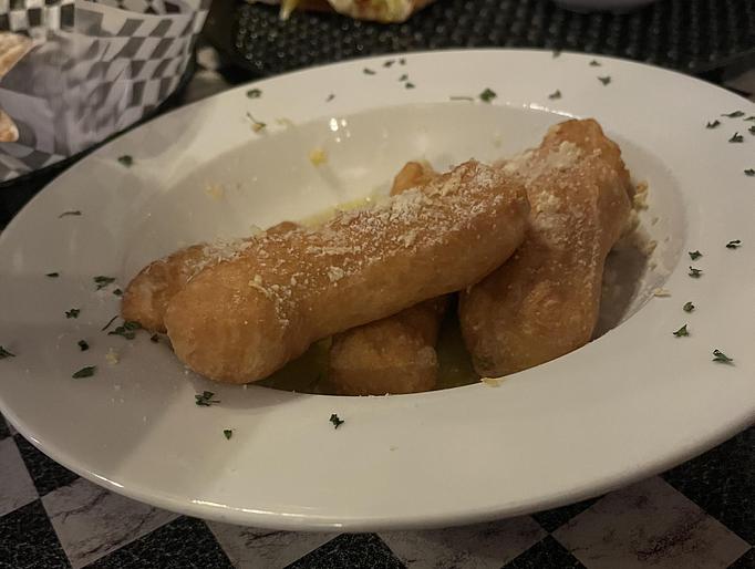 Product: Our handmade pizza dough deep fried and tossed in extra virgin olive oil, fresh garlic and Romano cheese. - Nikolas Pizza in Newport, RI Pizza Restaurant