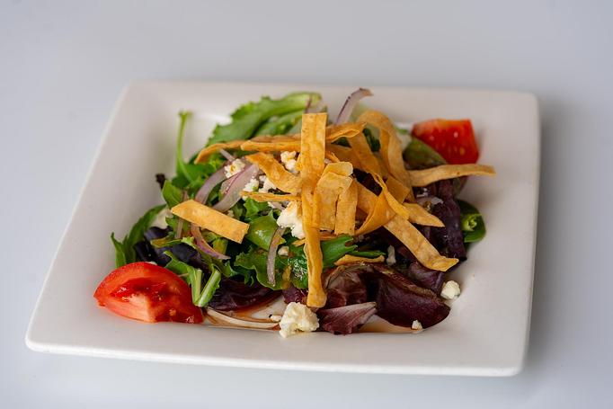 Product: Mixed greens, tomato, red onion, gorganzola cheese, corn strips, tomato-cilantro vinaigrette. - Red Mesa Restaurant in St Petersburg, FL Mexican Restaurants Product: Mixed greens, tomato, red onion, gorganzola cheese, corn strips, tomato-cilantro vinaigrette. - Red Mesa Restaurant in St Petersburg, FL Mexican Restaurants