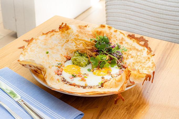 Product: Large oaxaca cheese quesadilla topped with ranchero sauce, sunny side eggs, crema, avocado, and tortilla strips - Summer House - Las Vegas in Las Vegas, NV Restaurants/Food & Dining
