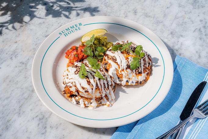 Product: Two tostadas topped with pulled chicken, silky black beans, ranchero sauce, jack cheese, sunny side eggs - Summer House - Las Vegas in Las Vegas, NV Restaurants/Food & Dining
