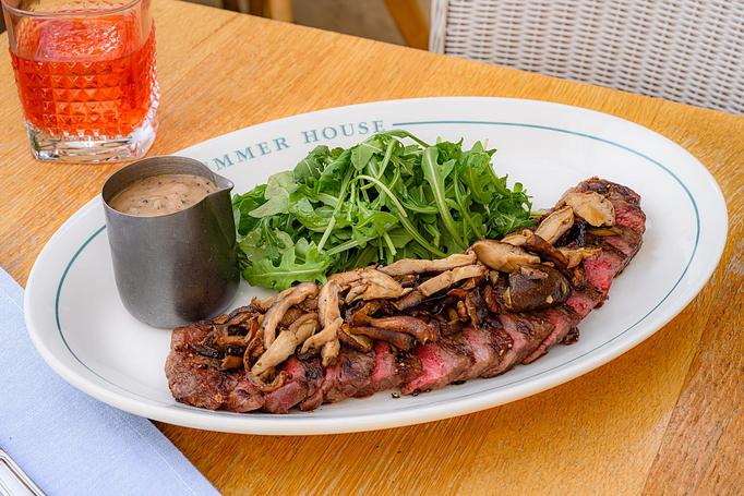 Product: Westholme Wagyu new york strip steak served with peppercorn sauce and forest mushrooms on the side - Summer House - Las Vegas in Las Vegas, NV Restaurants/Food & Dining