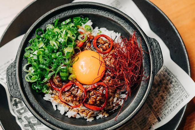 Product: tender ground chicken thigh is slow-simmered with poblano pepper and thai basil before being coal-roasted in a cast iron bowl atop sushi rice. topped with chili threads and green onion. mix the raw egg yolk through to incorporate all flavors and textures. - Sushi San - Reservations in River North - Chicago, IL Japanese Restaurants