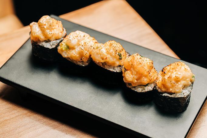 Product: chopped hudson canyon scallop mixed with spicy mayo, wasabi tobiko, and garlic is served atop hosomaki-style sushi filled with avocado and jalapeño. torched and finished with togarashi ichimi. available in 5 or 10 pieces. - Sushi San - Reservations in River North - Chicago, IL Japanese Restaurants