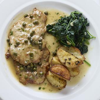 Product: Pan-fried and floured veal scallopini topped with white wine and lemon sauce with capers, seasonal vegetables and potatoes - Angelino Restaurant in Sausalito, CA Italian Restaurants