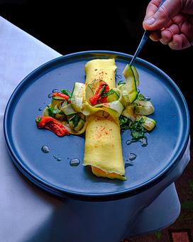 Product: Summer Vegetable Omelette

Marinated Feta, Shaved Summer Squash, Preserved Shiitake Mushrooms, Confit Tomato, White Balsamic Dressing - Brennan's - Wine Cellar in French Quarter - New Orleans, LA Cajun & Creole Restaurant