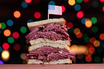 Product: Pastrami meat sandwich served on rye toast and cut in half with the two halves stacked on top of each other - Bub City in Rosemont, IL Barbecue Restaurants