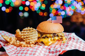 Product: Cheeseburger on a white plate with waffle-style French fries - Bub City in Rosemont, IL Barbecue Restaurants
