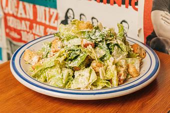 Product: Bowl of lettuce tossed in salad dressing and topped with croutons and cheese - Bub City in Rosemont, IL Barbecue Restaurants