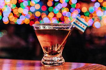Product: Stemless martini glass filled with a reddish hue beverage and a Chicago flag attached to a toothpick - Bub City in Rosemont, IL Barbecue Restaurants