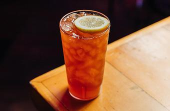 Product: Tall plastic cup filled with tea-colored beverage, ice and topped with a lemon slice - Bub City in Rosemont, IL Barbecue Restaurants