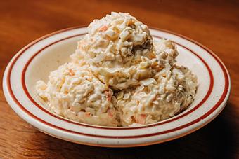 Product: White bowl filled with three scoops of coleslaw - Bub City in Rosemont, IL Barbecue Restaurants