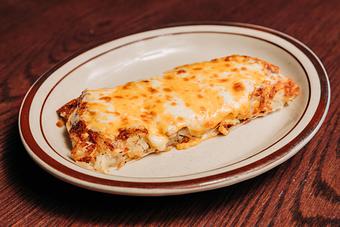 Product: Serving of crispy hashbrown potatoes on a white plate with melted cheese on top - Bub City in Rosemont, IL Barbecue Restaurants