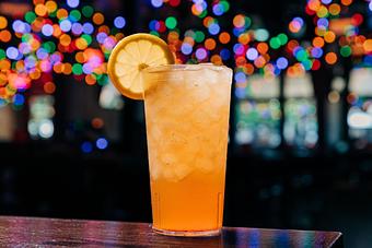 Product: Light colored beverage served in a tall glass with ice and a sliced lemon wheel on the rim of the glass - Bub City in Rosemont, IL Barbecue Restaurants