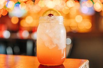Product: Pink beverage served in a mason jar and topped with a lemon slice and cherry - Bub City in Rosemont, IL Barbecue Restaurants