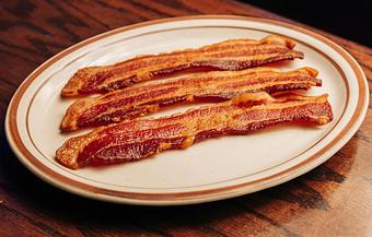 Product: Three slices of bacon served on a white plate - Bub City in Rosemont, IL Barbecue Restaurants