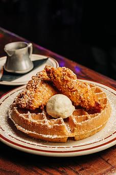 Product: Thick waffle topped with two chicken tenders, butter and powdered sugar - Bub City in Rosemont, IL Barbecue Restaurants