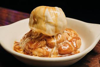 Product: Cinnamon cookie in a white bowl topped with vanilla ice cream and caramel - Bub City in Rosemont, IL Barbecue Restaurants