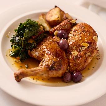 Product: Brick fried bone-in half local chicken with a spicy diavola sauce of chili pepper, olives, rosemary, and vinegar with seasonal vegetables and potatoes - Angelino Restaurant in Sausalito, CA Italian Restaurants