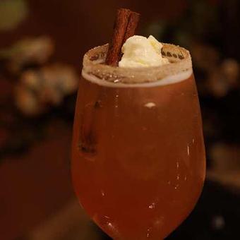 Product: Cranberry juice, orange juice, cinnamon, ginger ale. Garnished with a cinnamon stick and cinnamon and sugar rim. Add a scoop of ice cream for an extra sweet treat. - Chateau Faire Le Pont Winery in Wenatchee, WA American Restaurants