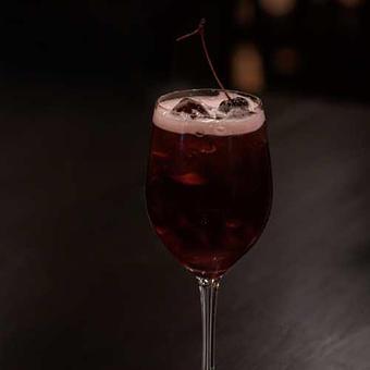 Product: Cranberry juice, lemon, cherry juice, vanilla. Topped with a cherry. - Chateau Faire Le Pont Winery in Wenatchee, WA American Restaurants