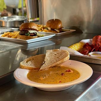 Product: Warm-up with our delicious Lobster Stew, a Local Favorite! - Geddy's in Downtown Bar Harbor, just steps from the town pier. - Bar Harbor, ME American Restaurants