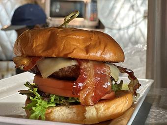 Product: An American Classic - The MDI Burger with Cheese, Lettuce, Tomato, and Crispy Bacon! - Geddy's in Downtown Bar Harbor, just steps from the town pier. - Bar Harbor, ME American Restaurants
