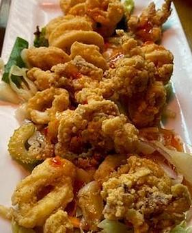 Product: Crispy, Golden, & Irresistible! Our crispy calamari is lightly fried to perfection and served with a zesty chili sauce. A crowd favorite at Geddy's! - Geddy's in Downtown Bar Harbor, just steps from the town pier. - Bar Harbor, ME American Restaurants