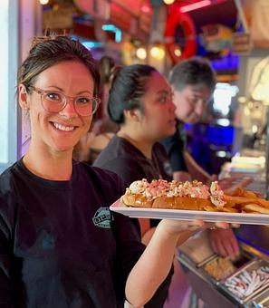 Product: Overflowing with fresh lobster and coast flavor -- Geddy's Kind Tide Lobster Roll is a seafood lover's dream! Lobster Roll Royalty! - Geddy's in Downtown Bar Harbor, just steps from the town pier. - Bar Harbor, ME American Restaurants