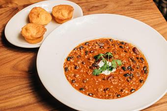 Product: organic ground turkey, red and black beans. finished with crema, cilantro and served with house-made cornbread muffins (just like mom used to make) - Hub 51 in River North - Chicago, IL American Restaurants