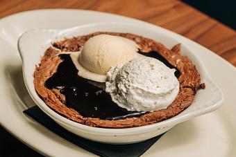 Product: house-made dark chocolate brownie, topped with vanilla bean ice cream, whipped cream, hot fudge, chocolate chips - Hub 51 in River North - Chicago, IL American Restaurants