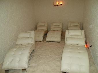 Interior: Salt Room Therapy, ceiling and wall are coated with salt, floor are lay out of crystal salt with a nice relaxing lounge chair you can read a book or magazine, listen to your own relaxing music or just simply enjoy and take a nap - Aadvanced Bodyworx, in Daytona Beach, FL Day Spas