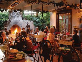 Interior: Our year-round outdoor patio with fireplace - Del Charro Saloon in Downtown Santa Fe - Santa Fe, NM American Restaurants