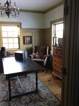 Interior: A wood paneled office with William & Mary table for a desk and a late 1700's dresser with hand carved shell design. - Just A Little Bit Country & Log Cabin Hooked Rugs in Waukesha, WI Cabins Cottages & Chalet Rental