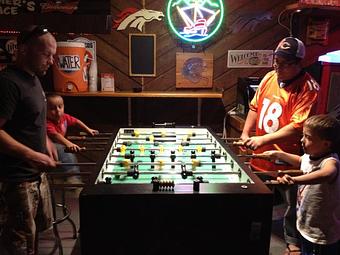 Interior: Daddys n Kids playing foosball - My Brother's Place in Historical Downtown Main Street - Canon City, CO Bars & Grills