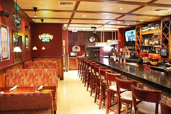 Interior: Come join us in the pub where we feature a full bar and several big screen TV's to catch all the sports action!  We carry the NFL Sunday Ticket along with many other sports channels so you are sure to catch your favorite team! - Revelry Pub & Grill in Sarasota, FL American Restaurants