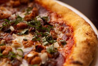 Product: With many topping options like Pepperoni, Bacon, Italian Sausage, Onions, Black Olives and Mushrooms you can create your own Stone Oven Pizza. - 22 & Vine in Riverside, IA American Restaurants