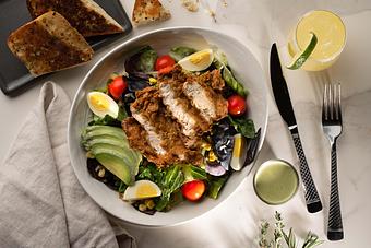 Product: Featuring Heirloom Greens, Fried Chicken, Hard Boiled Egg, Cherry Tomatoes, Toasted Pumpkin Seeds, Chihuahua Cheese, Green Goddess Dressing - 22 & Vine in Riverside, IA American Restaurants