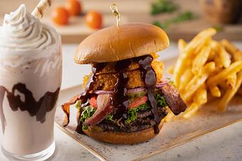 Product: Thick Cut Bacon, Cheddar Cheese, Onion Rings, BBQ, Brioche Bun - 22 & Vine in Riverside, IA American Restaurants