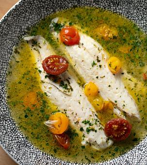 Product: Branzino, fish stock, baby heirloom tomatoes, chopped parsley, lemon - Bello by Sandro Nardone in Newport Beach, CA Bars & Grills