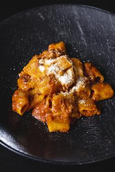 Product: Amatriciana - Bigoli Pasta & Crispy Cured Pork Jowl, Cooked into a Slightly Spicy Tomato Sauce with Pecorino Romano Cheese. Very Flavorful, Rich Pork & Tomato Flavor. - Bello by Sandro Nardone in Newport Beach, CA Bars & Grills