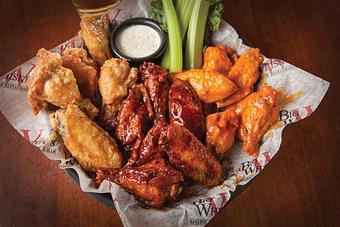 Product: Our classic award-winning jumbo wings are cooked to perfection, tossed in our choice of sauce and served with celery, ranch, or bleu cheese. - Big Whiskey's American Restaurant & Bar in Ozark, MO American Restaurants