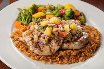 Product: Tender grilled chicken breast glazed with a sweet and spicy Hawaiian sauce. Topped with fresh pineapple salsa and served with Spanish rice and steamed vegetables. - Big Whiskey's American Restaurant & Bar in Ozark, MO American Restaurants