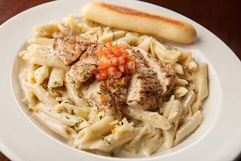 Product: Our original ranch alfredo sauce tossed with penne pasta and crisp bacon. Topped with tender grilled chicken, diced tomatoes and smoked Gouda cheese. - Big Whiskey's American Restaurant & Bar in Ozark, MO American Restaurants