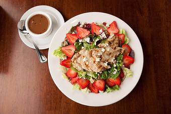 Product: Sliced strawberries, toasted almonds, sun-dried craisins, sunflower seeds and Gorgonzola cheese over fresh salad greens. Served with balsamic vinaigrette topped with tender strips of grilled chicken. - Big Whiskey's American Restaurant & Bar in Ozark, MO American Restaurants