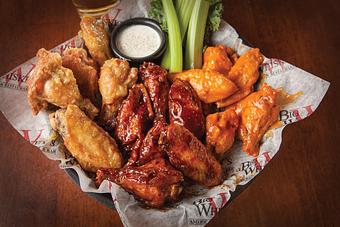 Product: Our classic award-winning jumbo wings are cooked to perfection, tossed in our choice of sauce and served with celery, ranch, or bleu cheese. - Big Whiskey's American Restaurant & Bar in Springfield, MO American Restaurants
