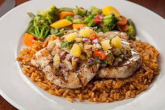 Product: Tender grilled chicken breast glazed with a sweet and spicy Hawaiian sauce. Topped with a fresh pineapple salsa and served with Spanish rice and steamed vegetables. - Big Whiskey's American Restaurant & Bar in Springfield, MO American Restaurants