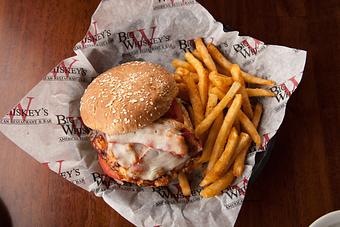 Product: Grilled chicken breast, smothered in BW's Original Buffalo Sauce with shredded lettuce, tomato, and chipotle mayo. Topped with crisp bacon and melted swiss cheese and served on a wheat bun. - Big Whiskey's American Restaurant & Bar in Springfield, MO American Restaurants
