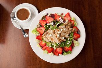 Product: Sliced strawberries, toasted almonds, sun-dried craisins, sunflower seeds and Gorgonzola cheese over fresh salad greens. Served with balsamic vinaigrette and topped with tender strips of grilled chicken. - Big Whiskey's American Restaurant & Bar in Springfield, MO American Restaurants